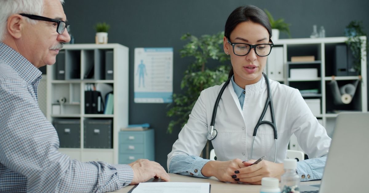 Doctor consulting a senior patient – health insurance for parents in UAE