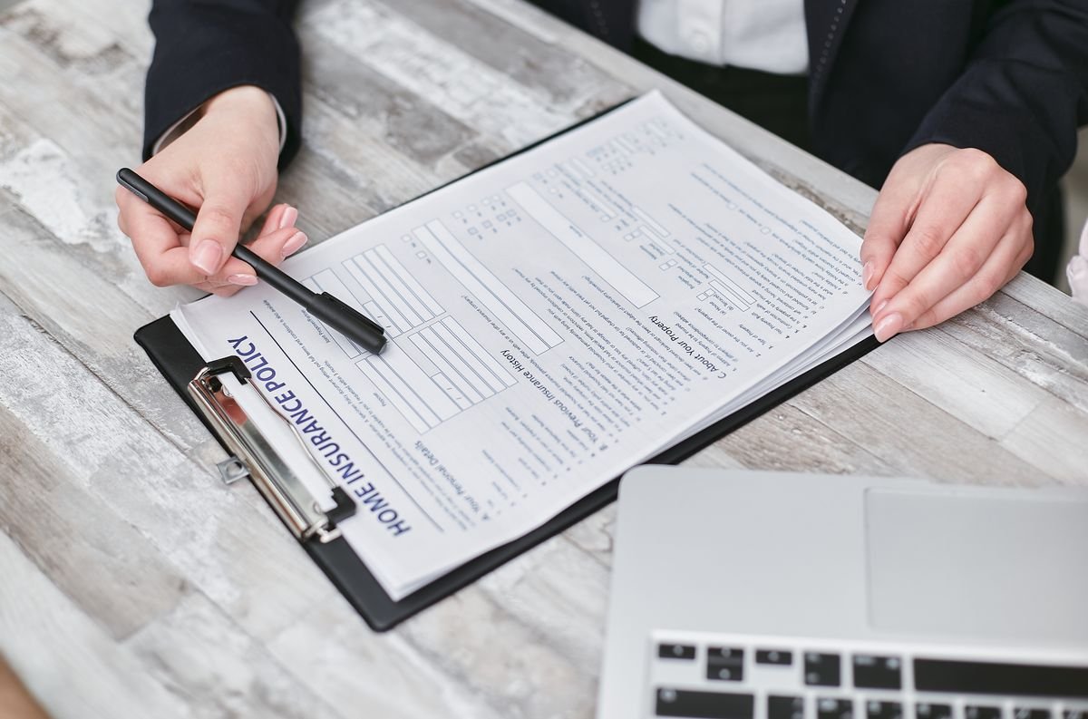 Person reviewing a home insurance policy document at home in the UAE