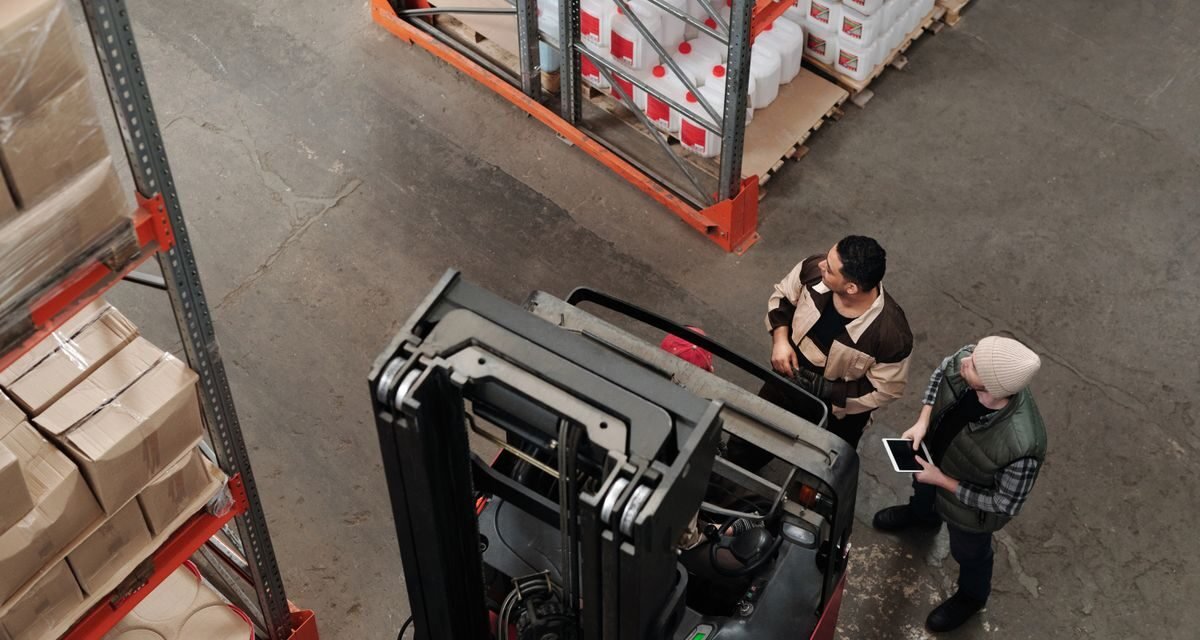 Warehouse employer and staff discussing health insurance benefits in the UAE