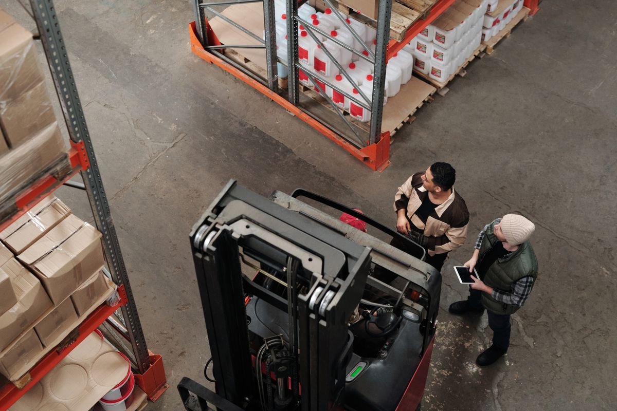 Warehouse employer and staff discussing health insurance benefits in the UAE