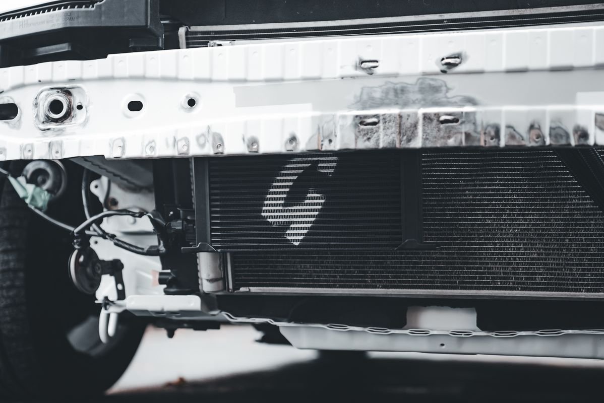 Close-up of a car front bumper and radiator, parts affected by body repair