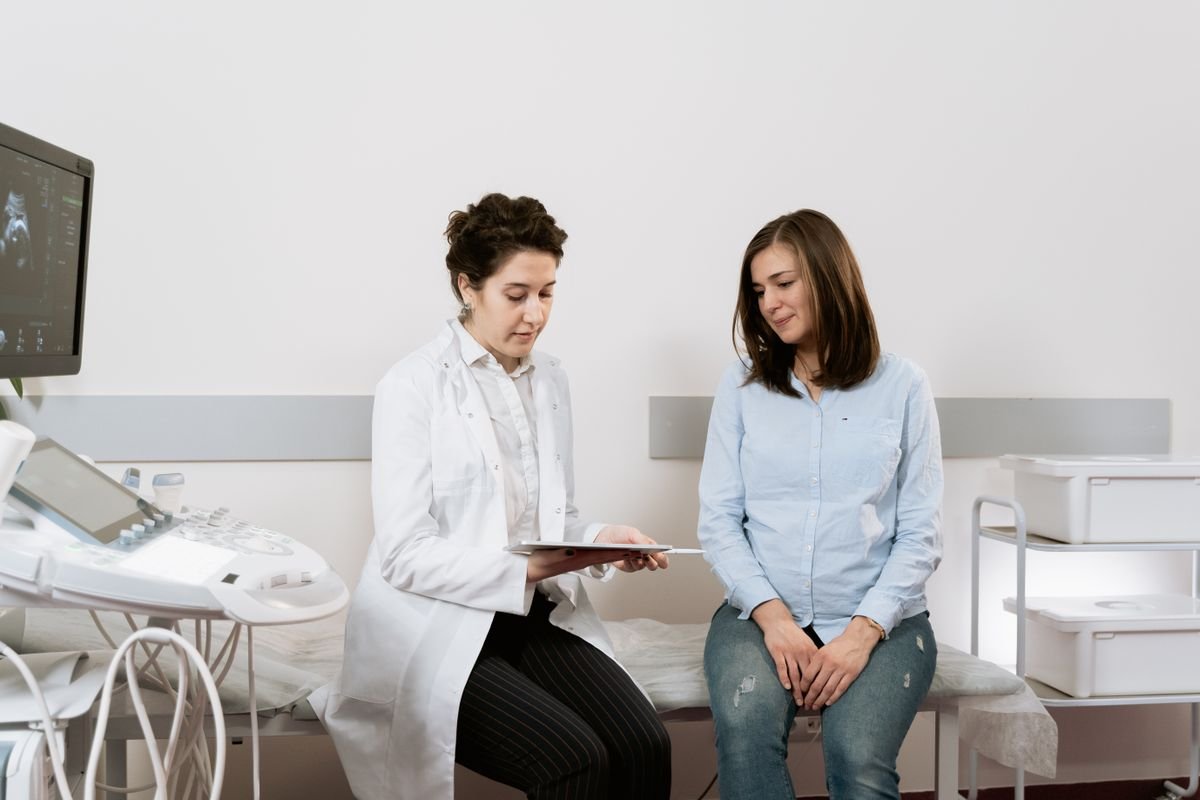 Pregnant woman consulting a gynecologist, representing maternity insurance in the UAE