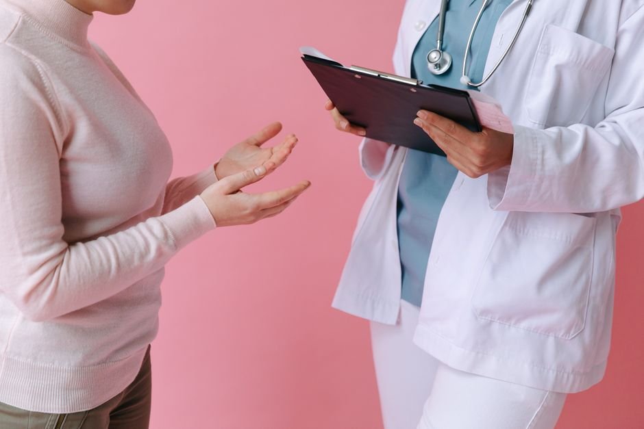Patient and doctor going through a medical history form with a clipboard