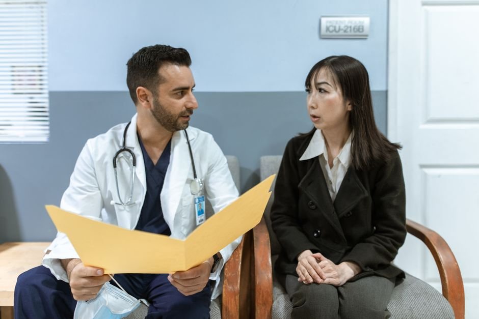 Doctor consulting a patient, illustrating pre-existing conditions and health insurance in the UAE