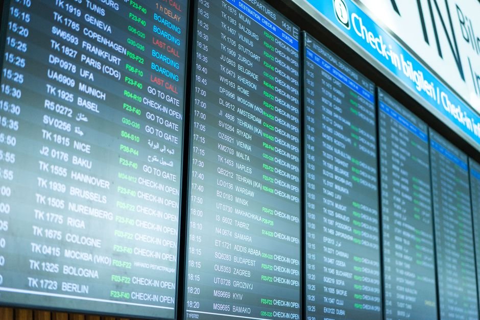Airport departures board showing flight schedules, relevant to travel insurance and flight cancellations in the UAE